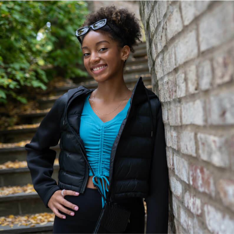 Women posing with her hand on her hip and a determined expression